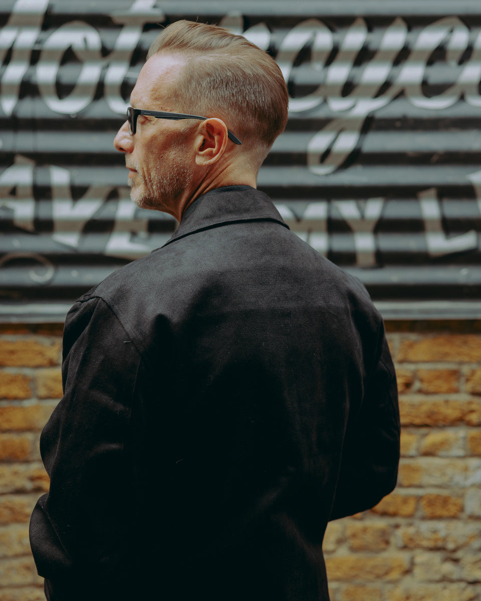 model wearing the black twill motorcycle jacket - back detail