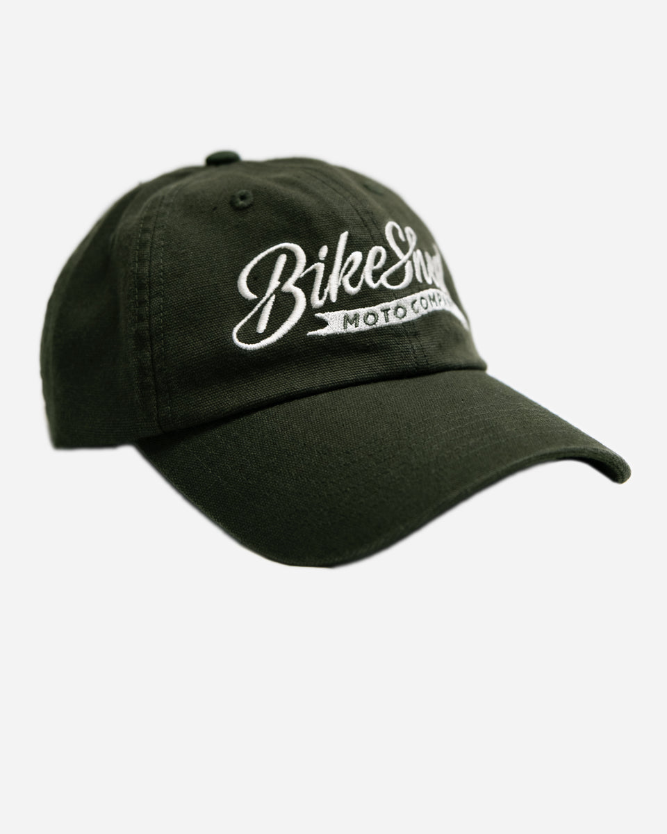 Green cap studio shot with 'Bike Shed Moto Company' logo on a white background