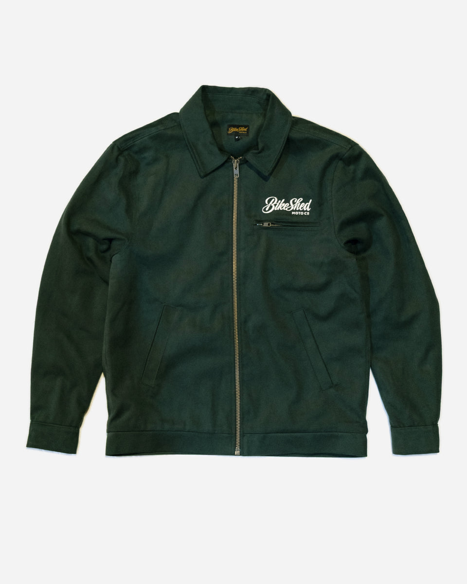 Green Motorcycle jacket with a Bike Shed Moto Co brand logo on a white background